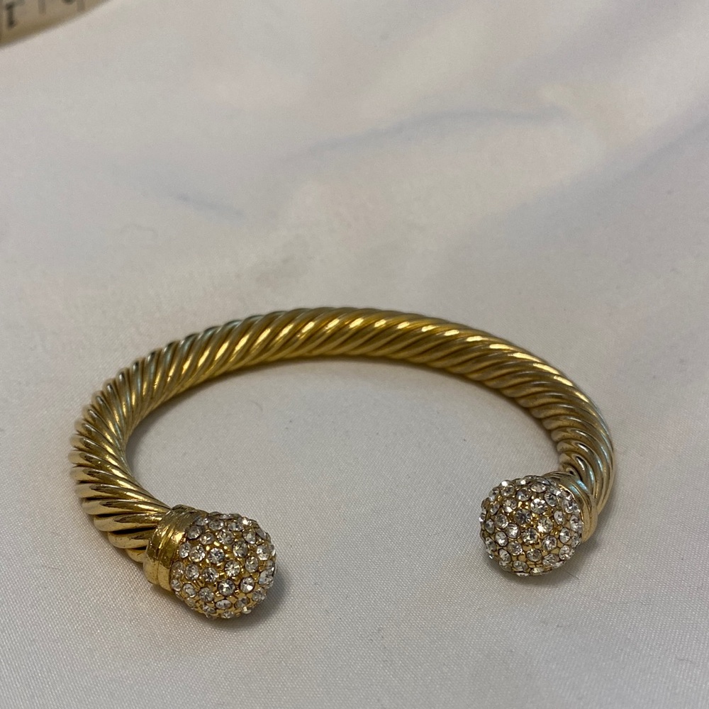 Elegant Gold-Tone Twisted Bracelet adjustable size. Fits 6-7.5 inch wrist.